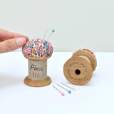 Embroidered pincushion, pin holder made using a wooden spool and Liberty fabric handmade by Stitch Galore
