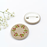 Embroidered holly wreath badge, holly pin badge handmade by Stitch Galore