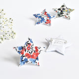 Christmas fabric star pin badge with red and blue berries, Liberty fabric star pin badge handmade by Stitch Galore