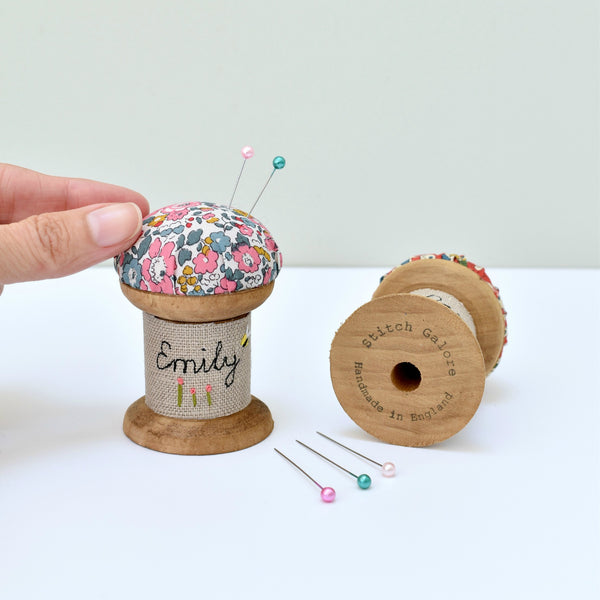 Embroidered personalised pincushion, pin holder made using a wooden spool and Liberty fabric handmade by Stitch Galore
