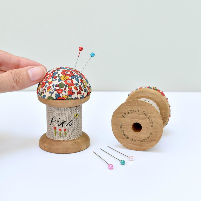 Embroidered pincushion, pin holder made using a wooden spool and Liberty fabric handmade by Stitch Galore