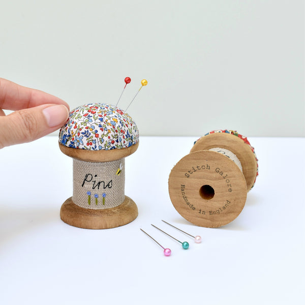 Embroidered pincushion, pin holder made using a wooden spool and Liberty fabric handmade by Stitch Galore