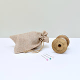 Pincushion, needle holder, sewing gift for made with a wooden bobbin and Liberty fabric handmade by Stitch Galore