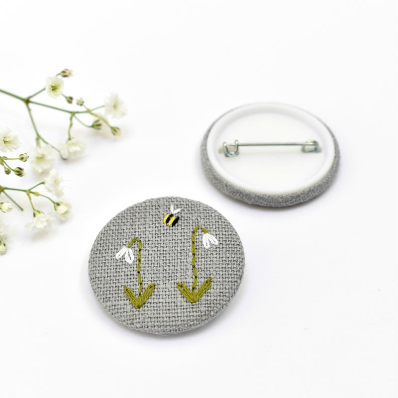 Embroidered badge with snowdrops and bee, floral pin badge handmade by Stitch Galore 